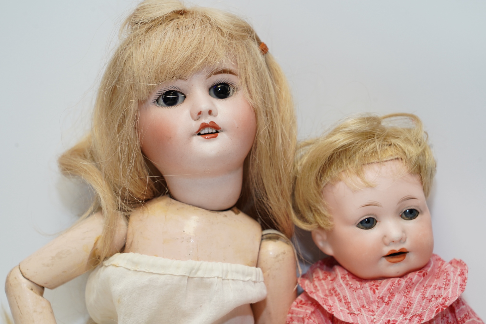 An AM bisque headed doll, an SFBJ 60 bisque doll and four miniature dolls. Condition - poor to fair